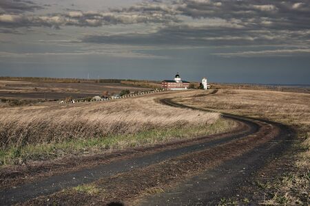 Typical Russian rural landscape with a field and a monastery.の写真素材