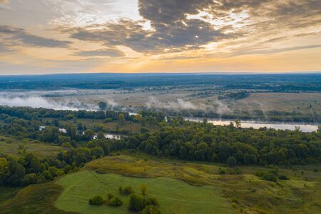 Aerial view of the smog over the waking city at dawn, in the distance buildings covered with fog and smogの写真素材