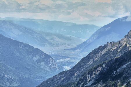 Natural mountain landscape. Steep wooded mountains, sky and rural view.の写真素材