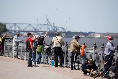 Astrakhan / Russia - May 25, 2020: Fishermen on the Volga River embankment fish People ignore social distance during the quarantine period.のeditorial素材