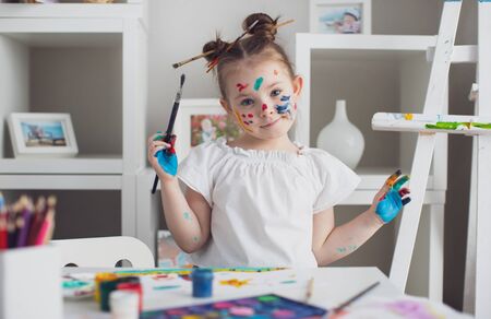 Cut girl painting in at her home. Selective focus . High quality photoの写真素材