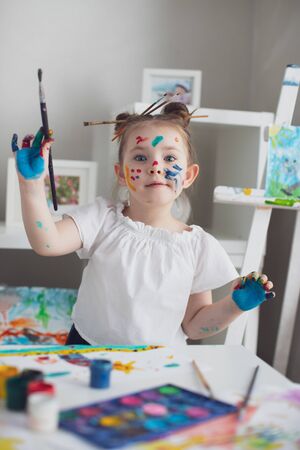 Cut girl painting in at her home. Selective focus . High quality photo