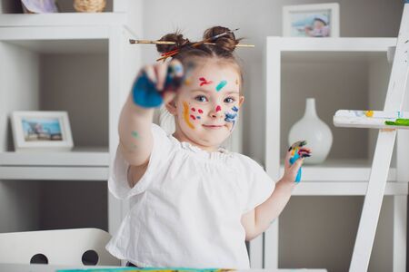 Cut girl painting in at her home. Selective focus . High quality photoの写真素材