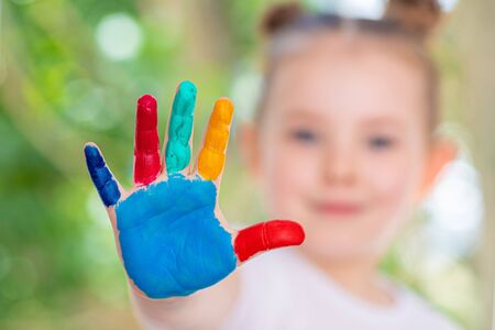 Little Girl featuring painted hands Concept Education, School, Creativity Selected Focus. High quality photoの写真素材
