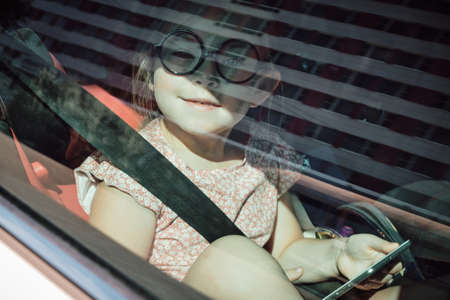 little girl sitting in the car. High quality photoの写真素材