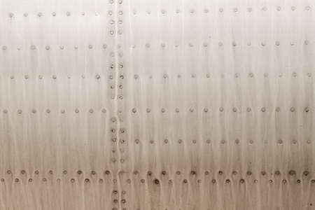 Old silver metal surface of the aircraft fuselage with rivets. High quality photoの写真素材