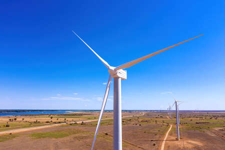 Wind Generator Turbine in Bright Sun Light on the Clear Blue Sky Background. High quality photoの写真素材