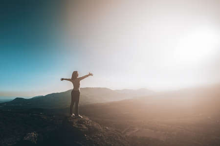 Female hiker with her arms up feeling free. High quality photo