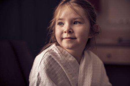 Portrait of a little girl in a white robe in a hotel. High quality photoの写真素材