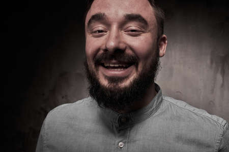 A handsome young man with a beard. The emotions of a man. Depression or hopelessness. Dramatic emotional portrait of a man. High quality photoの写真素材