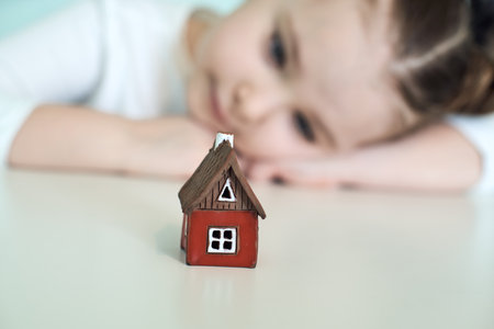 Small child with a red toy house. Selected focus. High quality photoの写真素材