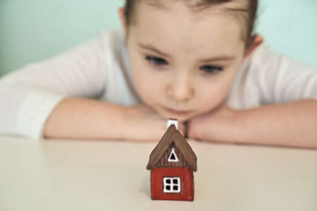 Small child with a red toy house. Selected focus. High quality photoの写真素材