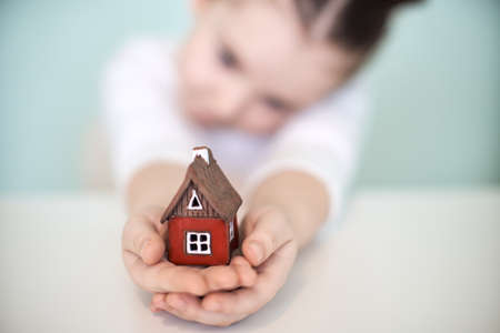 Small child with a red toy house. Selected focus. High quality photoの写真素材