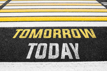 Pedestrian crossing with the inscription TODAY TOMORROW on the asphalt. High quality photoの写真素材