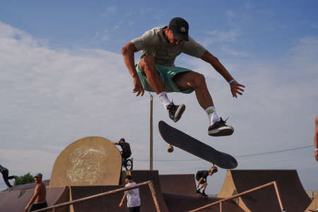 Olenevka, Russia - July 22, 2021: skateboarder jumping in a bowl of a skate park. High quality photoのeditorial素材