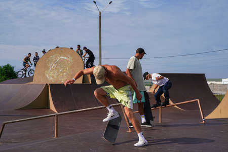 Olenevka, Russia - July 22, 2021: skateboarder jumping in a bowl of a skate park. High quality photoのeditorial素材