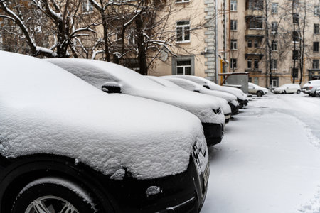 Moscow, Russia - December 1, 2021: Snow covered car after heavy snowfall in Moscow. The car is covered with snow and is parked in the courtyard of a residential area. High quality photoのeditorial素材