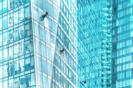 MOSCOW, RUSSIA - APRIL 19, 2022: Window washers on the skyscrapers of the Moscow City business center in Moscow, Russia. High quality photoのeditorial素材