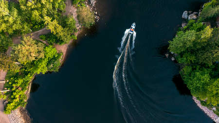 Top view of a white boat sailing in the blue sea. Top view of the boat. Aerial view luxury motor boat. A boat with a motor on blue water. High quality photoの写真素材