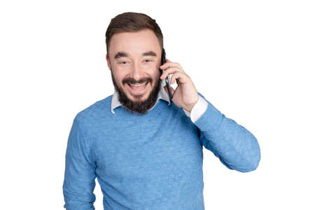 Smiling young business man posing isolated on white background in studio. Achievement career wealth business concept. Mock up copy space. Talking on mobile phone, looking aside. High quality photoの写真素材