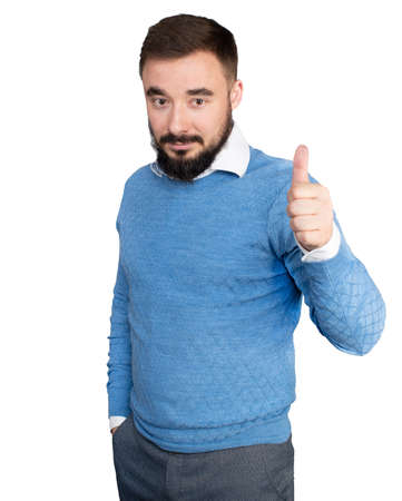 Young handsome man with beard wearing casual sweater over white isolated background approving doing positive gesture with hand, thumbs up smiling and happy for success. High quality photoの写真素材