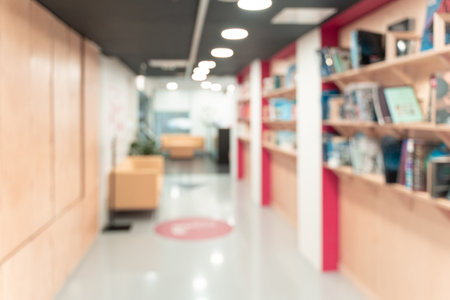 Blurred empty open space corridor. Abstract light bokeh at office interior background for design. High quality photoの写真素材