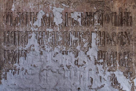 Stone shabby wall with ancient inscriptions. High quality photo