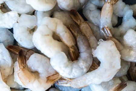 Frozen, raw shrimp. Texture: King Prawns background. Seafood on the counter. Fish market. Close-up of seafood. Photo of shrimp in a supermarket. Wholesale of seafood. High quality photoの写真素材