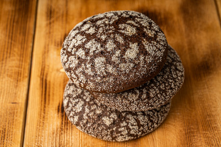 Round wheat bread and small rye bread rolls on a wooden background. Space for text. High quality photoの写真素材
