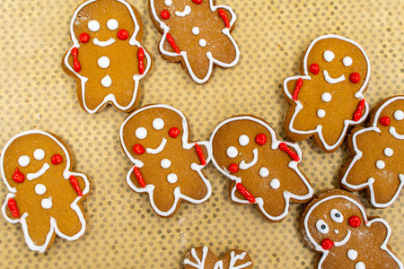 Gingerbread men, traditional Christmas cookies on baking paper. High quality photo