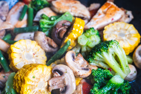 Background with vegetable texture. Corn, broccoli, mushrooms and green beans are fried in a pan. Close-up. The concept of healthy eating. High quality photoの写真素材