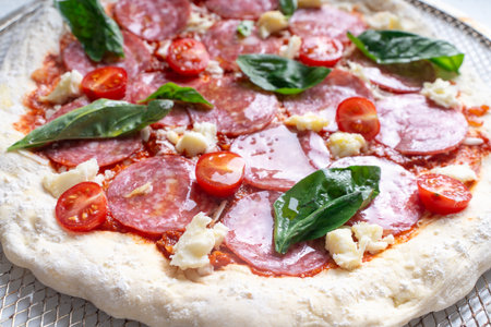 Pizza texture background with tomato sauce and cheese. Raw pizza close-up. High quality photoの写真素材