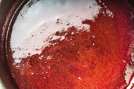 Background with a texture of red brown syrup with bubbles. High quality photoの写真素材