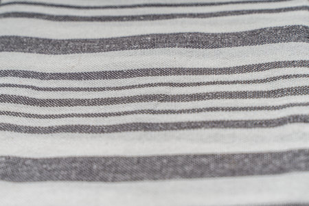 Background with white gray stripe fabric texture. A strict and laconic background with stripes of different widths. High quality photoの写真素材