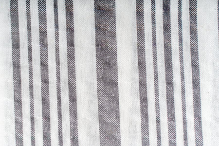 Background with fabric texture of white and gray stripes. A strict and laconic background with vertical stripes of different widths. High quality photoの写真素材