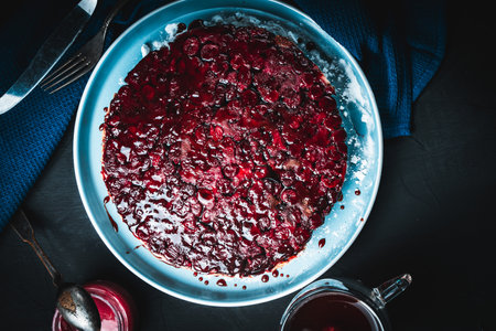 Cherry chocolate clafutis on a light blue plate on a dark background. French pie according to a traditional recipe. A quick homemade dessert. High quality photoの写真素材