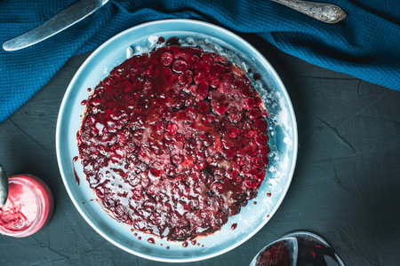 Cherry chocolate clafutis on a light blue plate on a dark background. French pie according to a traditional recipe. A quick homemade dessert. High quality photoの写真素材