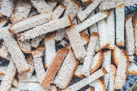 Background with the texture of slices of bread dried on a wire rack. Close-up of crackers or croutons. High quality photoの写真素材