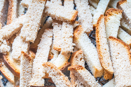 Background with the texture of slices of bread dried on a wire rack. Close-up of crackers or croutons. High quality photoの写真素材
