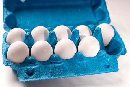 Delicious homemade pie, sprinkled with powdered sugar, on a blue plate with a blue napkin and a spoon. Top view, close-up. High quality photoの写真素材