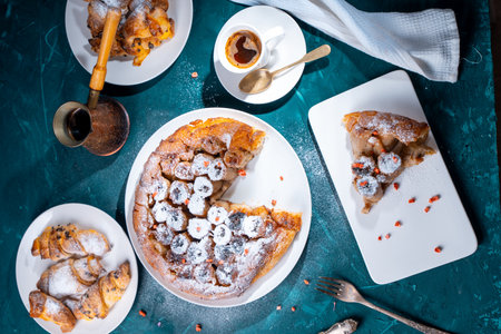 Traditional homemade caramel pie. French Tarte Tatin on a white plate with Turkish coffee on a green, emerald background. Top view. High quality photoの写真素材