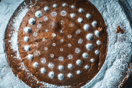 Background with pie texture. Homemade pie sprinkled with powdered sugar close-up, top view. High quality photoの写真素材