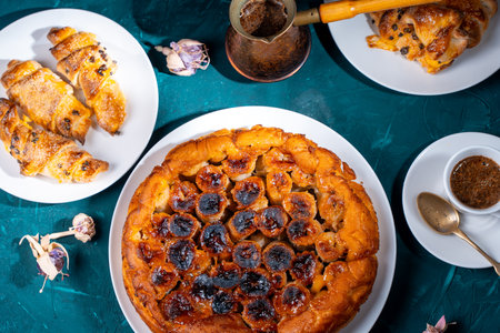 Traditional homemade banana caramel pie. French Tarte Tatin on a white plate with Turkish coffee on a green, emerald background. High quality photoの写真素材