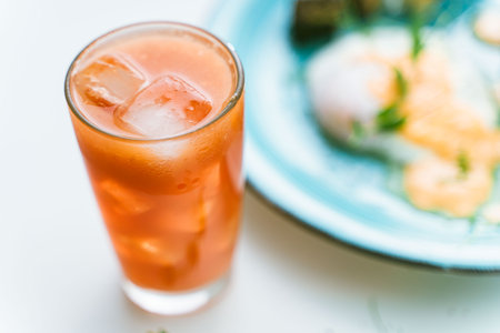 Grapefruit freshly squeezed juice with ice in a glass on a white background. A place to copy a space. High quality photoの写真素材