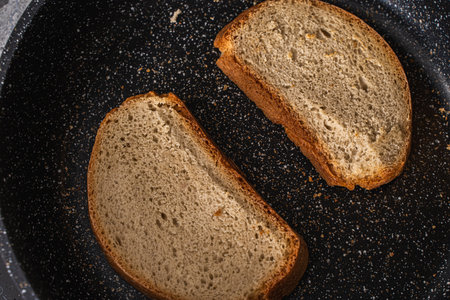 Bread toast is toasted in a black pan. High quality photoの写真素材