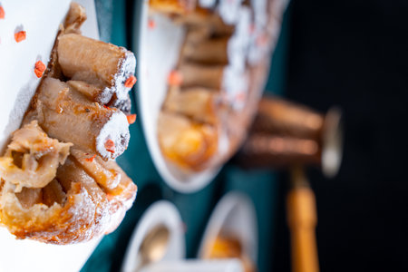 A piece of banana cake or pie and a cup of Turkish coffee on a white plate on a turquoise background. Dessert on the table. Vertical photo. High quality photoの写真素材