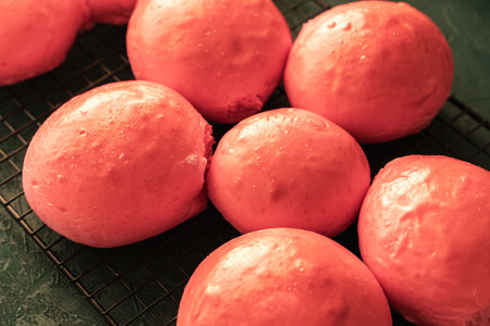 Freshly baked pink burger buns on a black grill. View from above. Close-up. High quality photoの写真素材