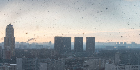 Panorama of a big city, it is snowing, cloudy and clear sky with snowflakes, aerial view of residential high-rise buildings. High quality photoの写真素材