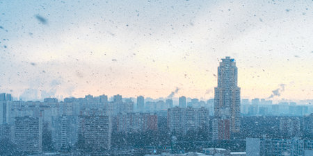 Panorama of a big city, it is snowing, cloudy and clear sky with snowflakes, aerial view of residential high-rise buildings. High quality photoの写真素材