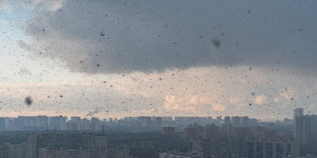Panorama of a big city, it is snowing, cloudy and clear sky with snowflakes, aerial view of residential high-rise buildings. High quality photoの写真素材